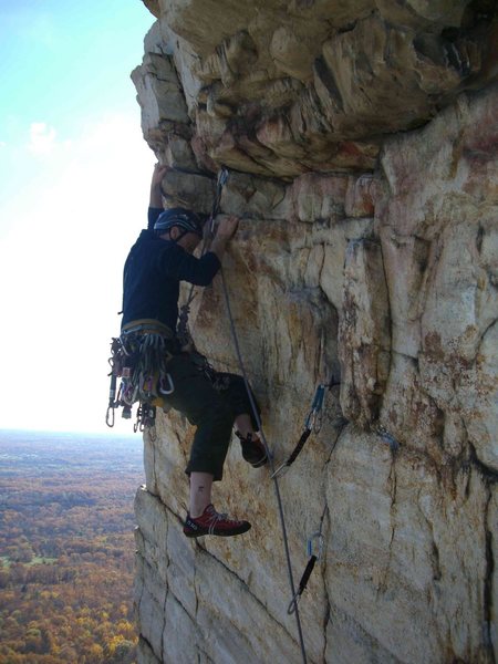 With the left hand on the jug, the short but pumpy traverse on Le Teton is done. Photo by Mark Schambra