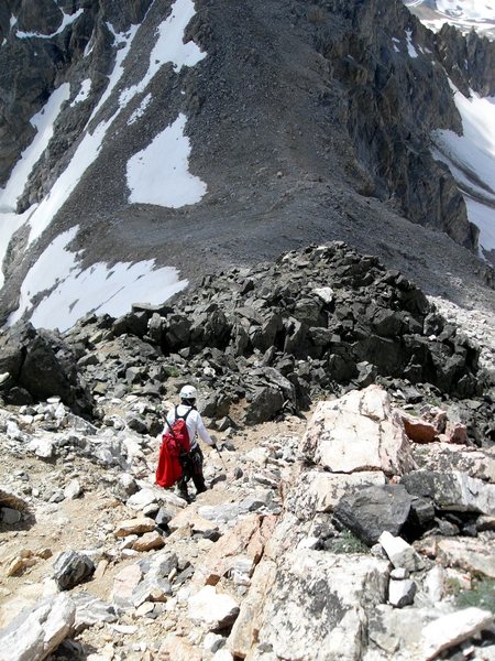Dave G. on the trail descending just above the Black Dike. Well below you can just make out the Exum Huts at the bottom of the Lower Saddle. The trail passes right in front of those huts.