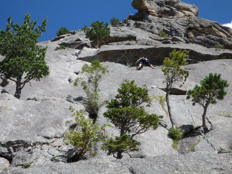 Traversing below the roof on the first pitch.