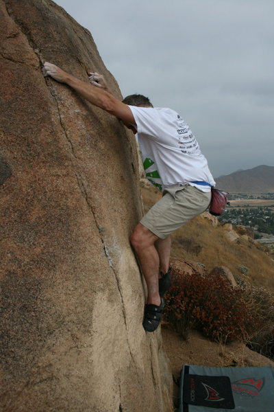 Kevin on the hardest problem on this boulder. Not much footing.
