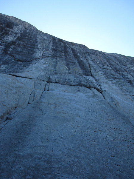 Cheetos starts up the left of the two, low-class crack systems to the white dike in the photo (the right crack is Holdless Horror). You can clip the first bolt when your feet are five feet above the ledge where the dike starts; some will want gear before the bolt.