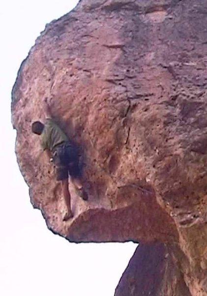 The crux sequence culminates in a powerful toss to a jagged mini-ledge.