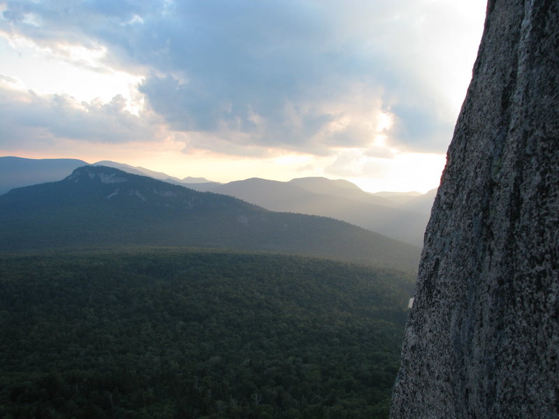 The view you get from the first belay of The RGC, looking towards Green's Cliff. The slabs of the Captain are on the mountain side just left of the sun.