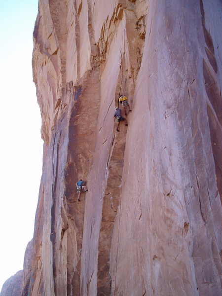 Brian Delaney on Another Roadside Distraction while unknown French climbers top out on Astro Lad. The second is being belayed from the ground while the leader films.