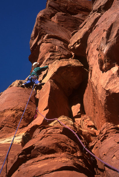 Tomas turning the limestone band just below the first pitch belay stance.