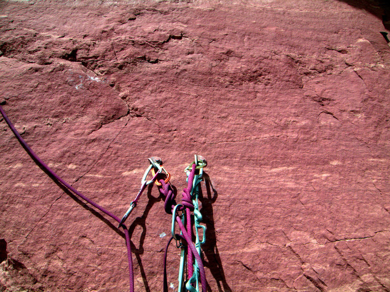 Not to be alarmist, but I noted the spiderwebbing series of hairline fractures that completely surround the closely spaced belay bolts- your sole security for starting the third pitch.