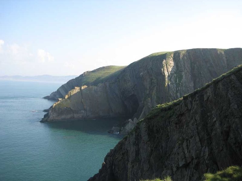 Baggy Point, with Long Rock Slab in the distance and Scrattling Zawn beyond. NB The tide is in! (photo by Phil Ashton)