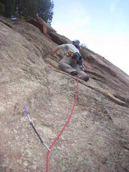 Heather begins leading up the runout Cracker Jack route.