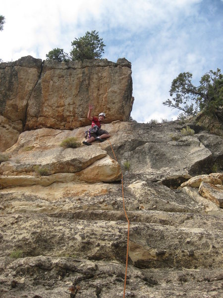 Climb straight up into the roof, then traverse out right and up to the paved Rim Trail.