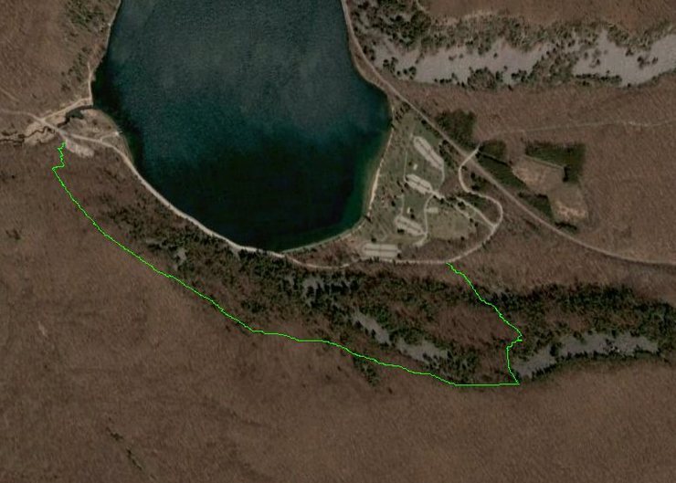This shows a very rough outline of the path I took to find this boulder yesterday.<br>
<br>
I started at the West Bluff lot and hiked to the Reserve which is maybe halfway along the green line (could be wrong). From the reserve I forged east along the top of several talus fields, dropping into most of them way before I needed to. Unlike the clean talus of the West and East bluffs, most of the talus I encountered was dirty, unstable and a real pain in the ass. The Ejaculator is a decent trip down so I'd recommend staying higher (more south) and in the woods. You can use the lake as your guide as you have a sense of where it is the whole time. You can start looking for the Ejaculator on your left once you've passed the eastern edge of the lake and the south shore parking lots are due north of you.<br>
<br>
To get down from the ejaculator I went downhill and trended slightly left coming out on South Shore drive just to the east of the southern most lot of the south shore. If you were to reverse this trip you could walk east out the southeast corner of this lot and look for a drainage pipe on your right. From there start questing up into the woods in a southeasterly direction. You won't be able to see the Ejaculator until you are all the way on top of the bluff. It wasn't fun coming down so I don't imagine it's too fun going up...