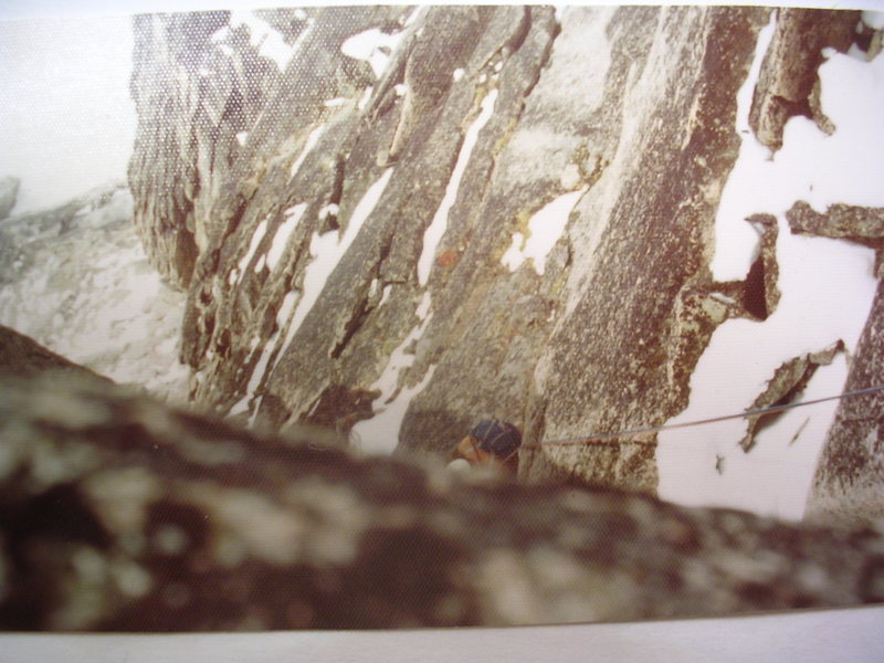 Alain Henault rappelling Kraus-Weissener, August, 1974.<br>
<br>
Bit snowy, eh? We had to wait out a week of bad weather and were getting kind of desperate for success.