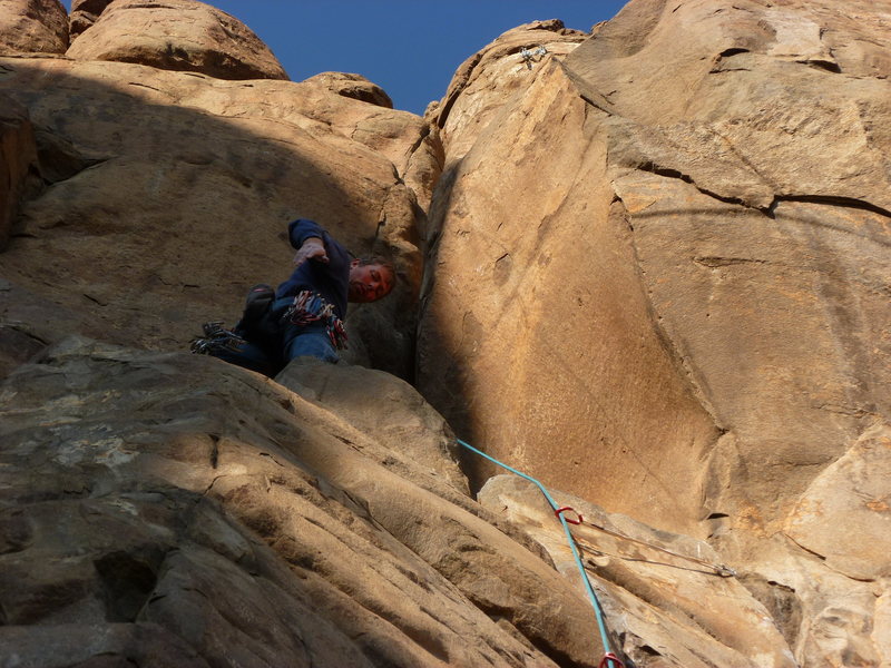 On the ledge below the crux slot.