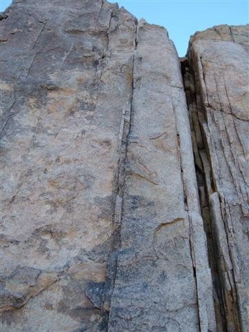 The route climbs the incipient crack just to the left of the wide crack.