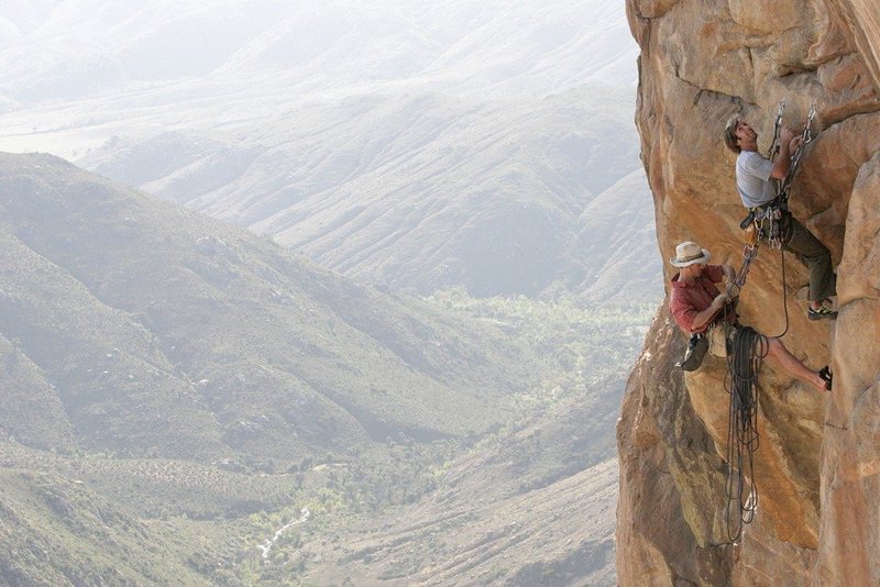 First pitch belay on Crazy Horse. Sharma linking into the crux pitch on Soy Chango, scoping the steeps! Credit Adam Kimmerly