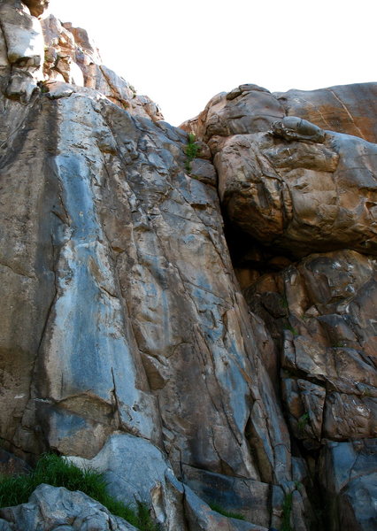 Left to Right:  Master of Dafeet follows the prominent grey water streak, Empathy starts 8' right, Lilley's Delight climbs the wide crack. The diagonal visible on the wall above is Sympathy.