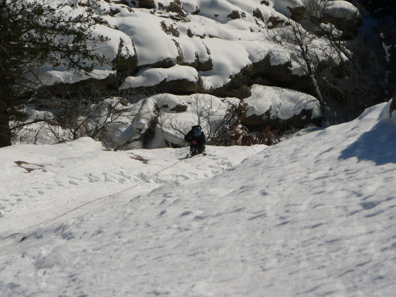 Kimberely following 1st pitch. This was a 60m rope stretcher with no pro. Thin but adequate ice on lower section and consolidated snow on upper part of pitch.