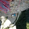 Shirley nearing the top of pitch 5 of the Punsola-Reniu route (6c or 6a A0) on Cavall-Bernat tower.