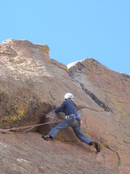 Just below the crux. Footholds on the face make the setup for the pull over the roof a little easier.