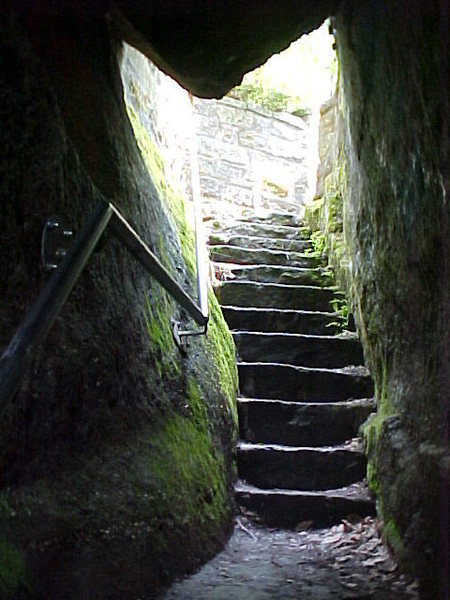 The upper section of the staircase that leads through the rocks to the base.