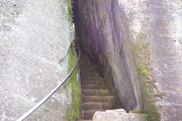 The lower section of the staircase that leads through the rocks to the base.