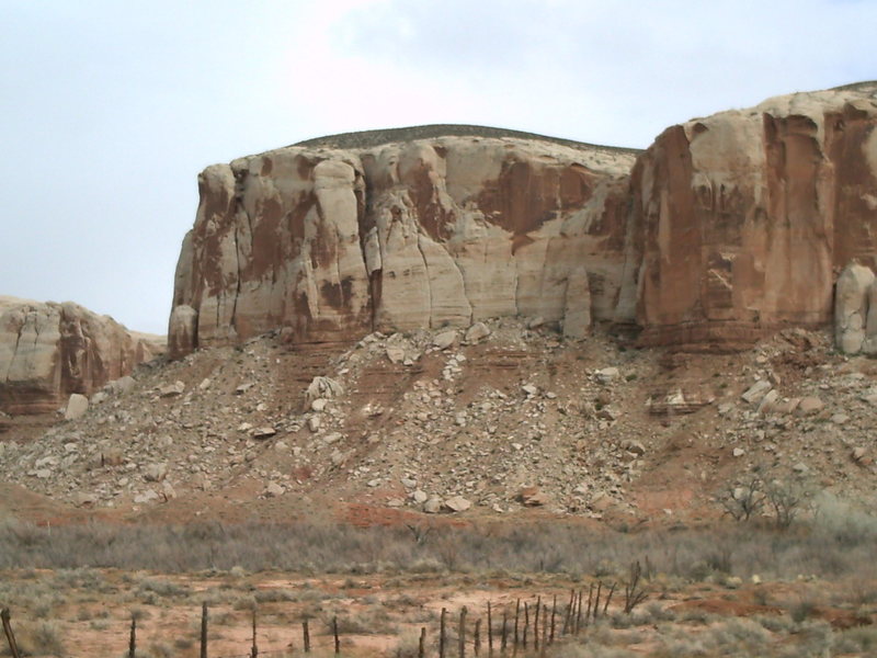 There are a few cracks with anchors over here. The two cracks in the center share an anchor. The route described is the left one.
