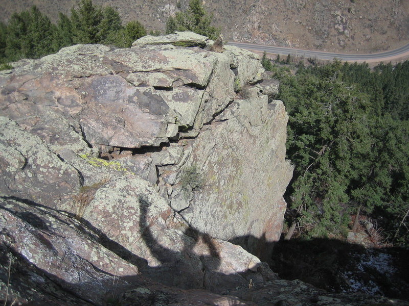 Looking from SW down on the crag from atop the rock slab just off the Beaver Brook Trail. BB Gun top anchors are 6 ft right of "EB" initials.