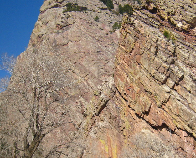 Climber stemming in orange.