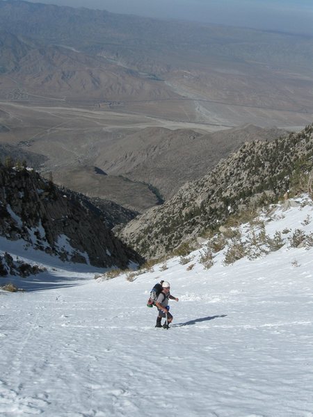 Paul cruising up the snow chute. The starting elevation can be seen wayyyyy in the background