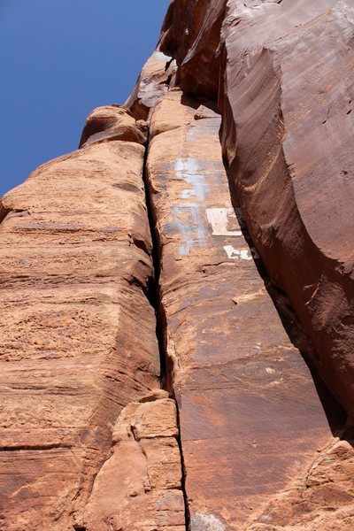 The Ooze (5.10-), Selfish Wall, Indian Creek, UT. Route lies right of the calcite patch. Photo courtesy Liba K at summitpost.