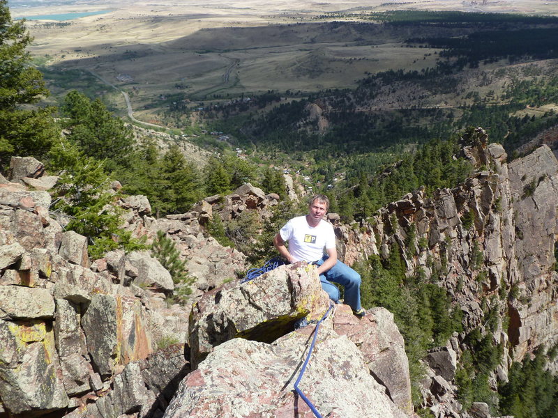 Mark Roth on the summit of the Potato Chip with Eldorado Springs far below.