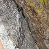 The "famous" pin/nut anchor on top of pitch 2.  You can get down from here with one rope, but I'd back it up with something if you do.  The pin flexes and is pretty rusted, and the nut likes to fall out....