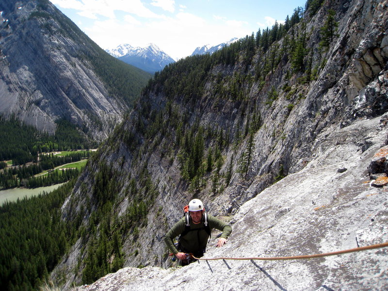 Just topping out the bolted 5th pitch steep section and coming up the "steps" to the belay. The less steep side of Tunnel Mountain is in the background.