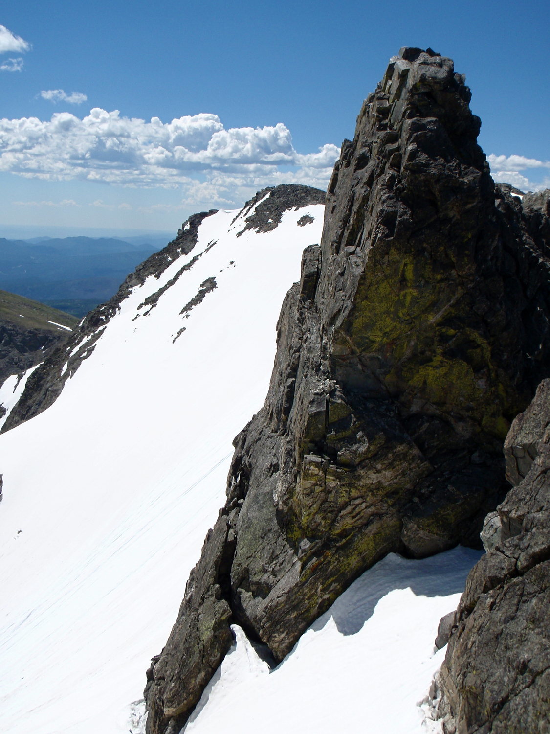 Looking back at a gendarme on the ridge and the summit of South