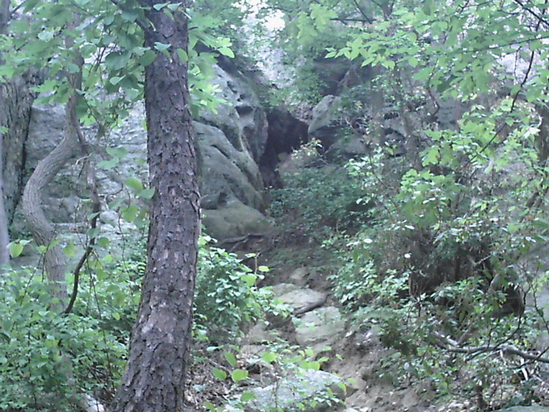 Gulley leads up to the entrance of Down Climb. Chimney Route starts halfway up on the left.