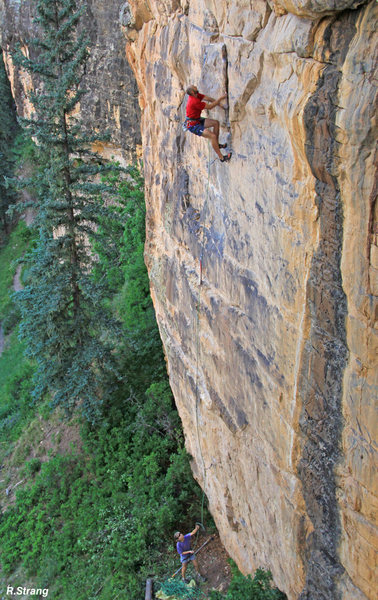 Alex climbs the fun layback before the crux during FA - Raising Awareness (5.12).