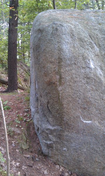 Spunky climbs this rounded arete straight up. Holds for a sit start are present.