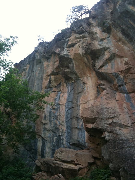 Le Frimeur climbs the left hand gray streak and Bovine Impact climbs the dihedral to the right in the orange rock.