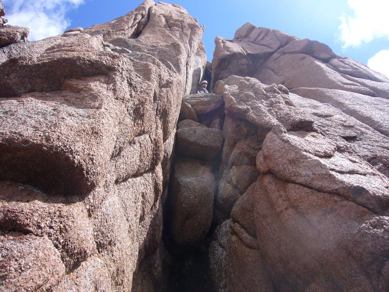 Top of Pitch 1 in west chimney. Notice large chockstone and dark alcove behind.