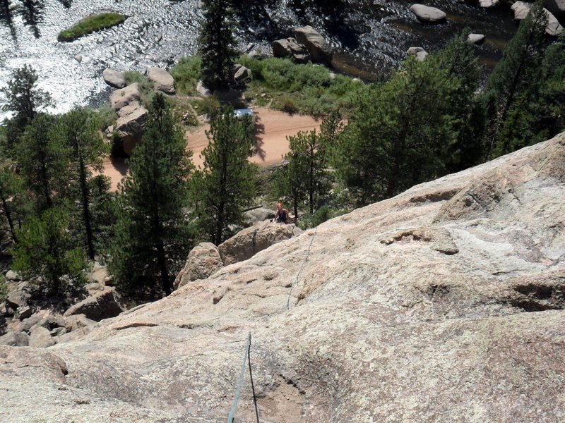 Looking down from the top of Arch Rock Direct to Brenda who is at the anchors at the top of the Middle Dihedral.