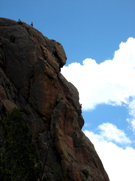 The Monument as seen from the Chicken Head Ranch. Climbers on P3 of Fire on the Mountain.<br>
<br>
Photo: Darren Mabe.
