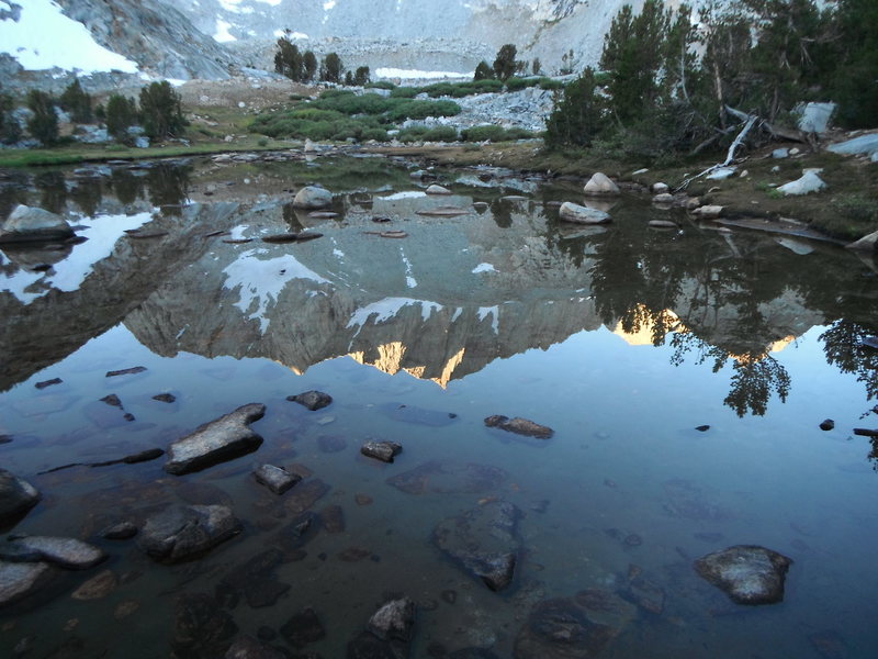 A reflection of the North Buttress, Mt Goode in Margaret Lake
