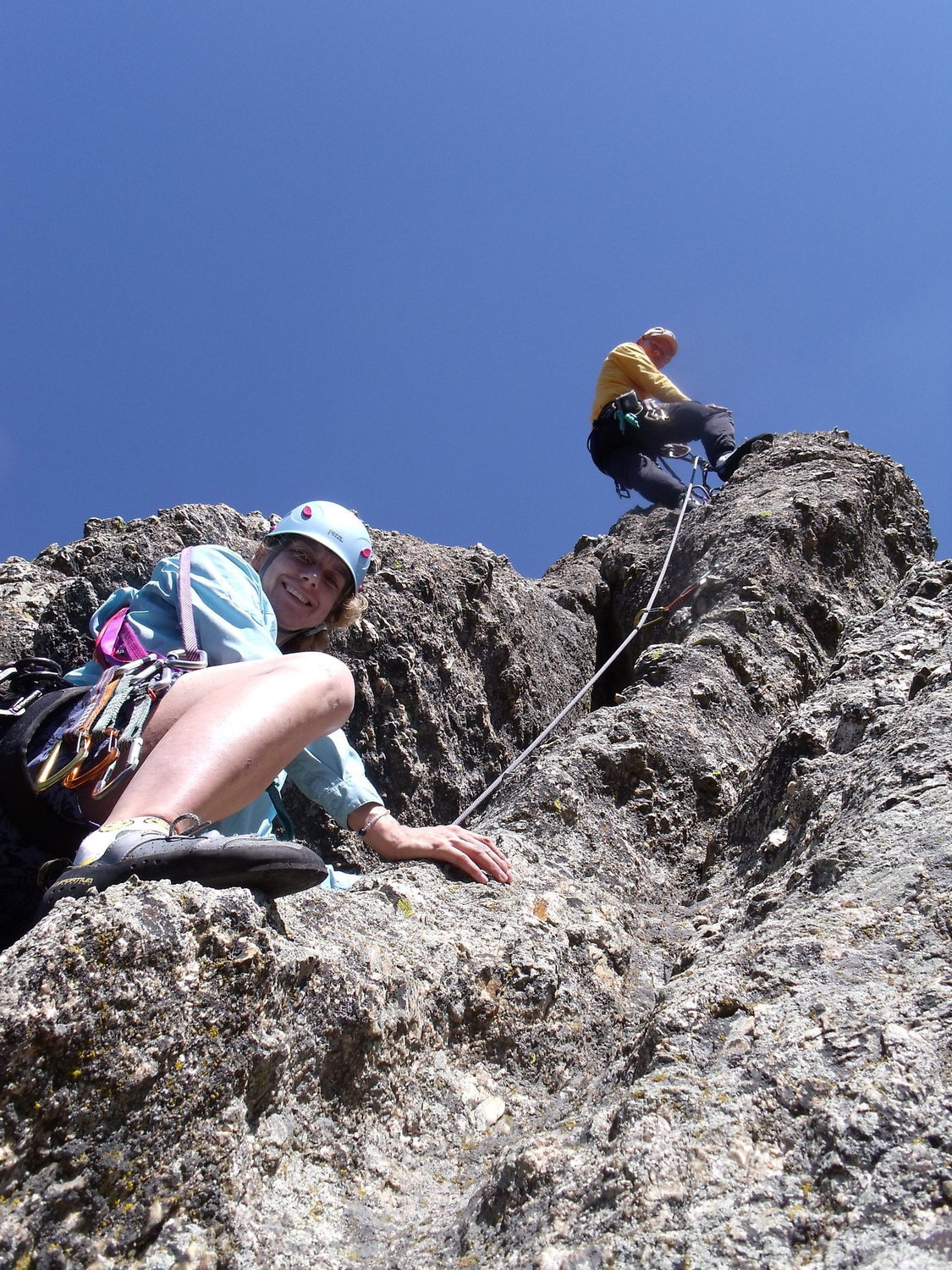 Paul Huebner belaying Anne Meyer up the short East Summit Pitch. (Photo