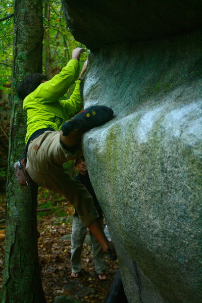 Al toe hooking on the Nick boulder just as it starts to pour rain.