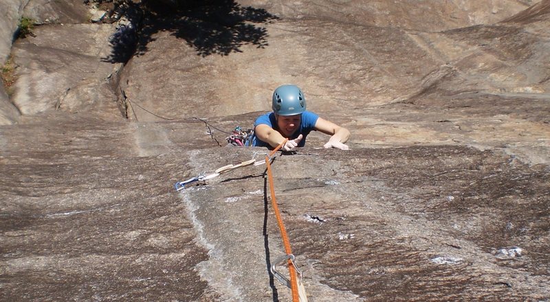 Mary making the thin moves to pull over the P1 crux bulge.