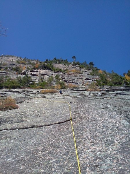 Bradley White leading the second pitch of Southern Migration. He went a little off route to the left being attracted to the anchors for the left hand variation. After clipping them, he moved back right onto the route.