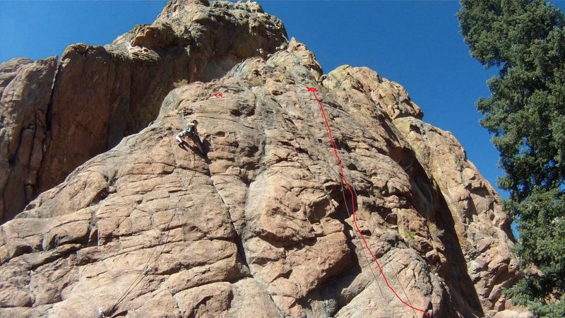 The top of Mr. Hanky. The route to the left with the climber is Junk In The Trunk, 5.9.<br>
<br>
Climber: Paula.