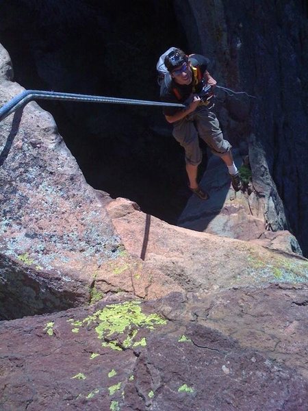 Looking down the rappel of The Maiden. Climber: R. Bame. Photo by K. Decker.
