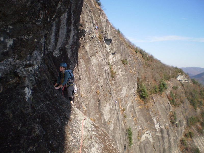 Mary making the traverse to the comfy ledge on the Traditions linkup below the 10a pitch.