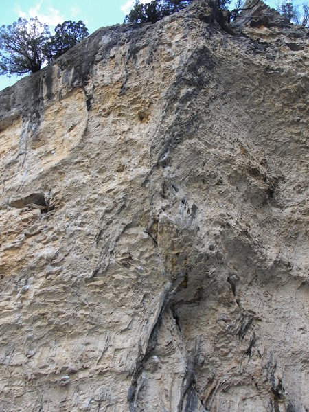 A Cravita follows the black streaks up the blunt arete.