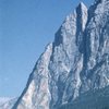 Punta Fiames rises steeply above Cortina d'Ampezzo; the very attractive "Spigolo Fiames" follows the arete sharply defined by sunlight and shadow at the upper right of the mountain